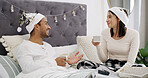 Smile, couple and coffee in bed with Christmas, present and festive season for love in home. House, man and woman with warm beverage in bedroom for Santa hat, gift and decoration for holiday bonding