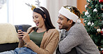 Christmas, phone and couple laugh in home for gift shopping, meme and relax together. Xmas, man and funny woman with mobile in living room for holiday joke, e commerce and festive discount online