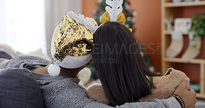 Buy stock photo Back, hug and couple in living room with Christmas tree, celebration and bonding together for holiday. Love, connection and people with embrace in home, festive season and relax for relationship