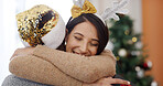 Christmas, couple and woman in living room with hug for holiday tradition, connection or gratitude. Bokeh, married people or embrace in apartment for festive season, appreciation or bonding together.
