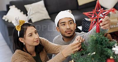 Buy stock photo Christmas, tree and couple with decoration in home for festive tradition, holiday season and celebration. December, above and man with woman with bauble, ornament and star for xmas, vacation and love