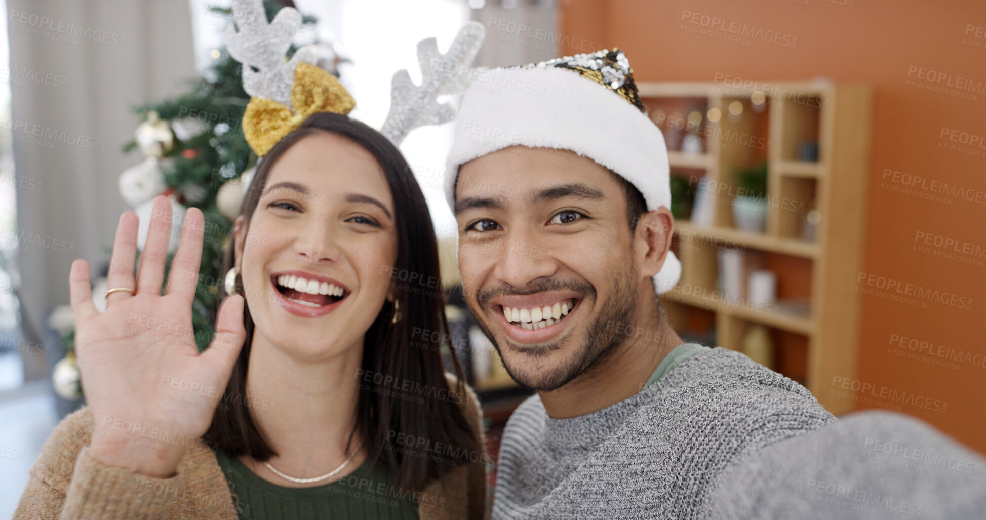 Buy stock photo Christmas, portrait and video call with couple in living room of home together for season greeting. Smile, streaming and wave with happy people in apartment for festive celebration or tradition