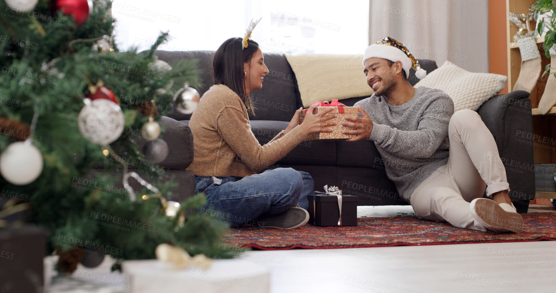 Buy stock photo Christmas, house and couple with smile, gift and bonding together with festive season, giving and surprise. Xmas, present or man with woman, decoration and celebration with holiday tradition and love