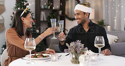 Buy stock photo Christmas, happy couple and cheers in home with champagne for holiday tradition, meal and bonding. Married people, toast and celebration in house with alcohol, food and connection for festive season.
