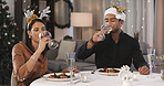 Christmas, couple and drinking wine in home with dinner for holiday tradition, meal and bonding together. Married people, alcohol or food in house with love for festive season, culture or connection.