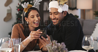 Buy stock photo Christmas, reading or couple with phone in home, check social media or watch celebration message video. Festive tradition, alcohol or happy people with season greeting text, holiday wishes or mobile