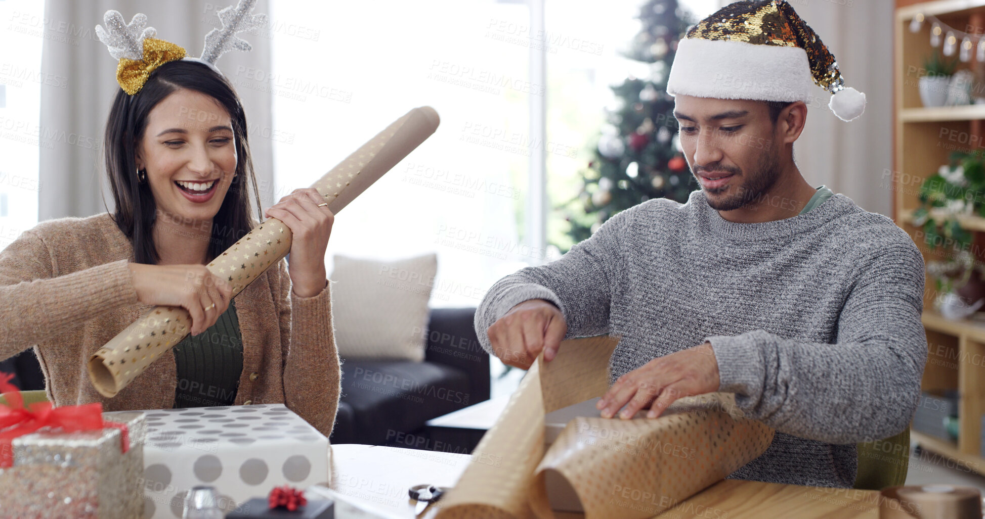 Buy stock photo Christmas, present and wrapping paper with couple in living room of apartment for festive tradition. Celebration, gift and teamwork with happy people in home for December or xmas holiday season