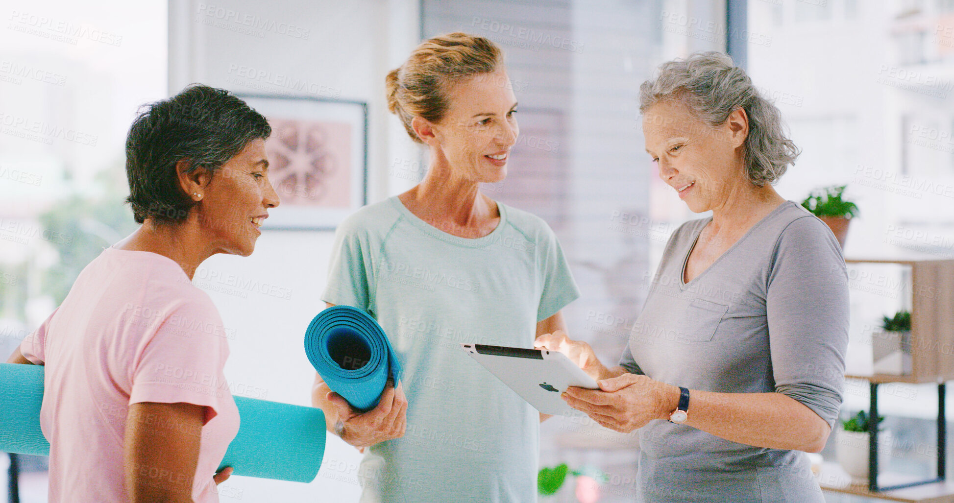 Buy stock photo Yoga class, tablet or mature people in studio, check registration information or digital enrolment. Membership, yogi or women with tech to review sign up sheet, online record and application form