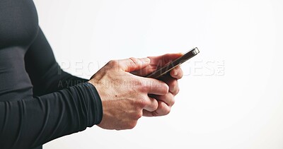 Buy stock photo Phone, hands and man in studio with fitness research, mobile app or workout plan for training. Technology, networking and male athlete with cellphone for sports communication by white background.