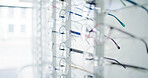 Optometry, closeup and glasses in store on display, eye wellness and consumer products in optical shop. Healthcare, frames and specs selection on rack, eyewear variety and collection in vision center