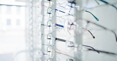 Buy stock photo Optometry, shelf and glasses in store on display, eye wellness and consumer products in optical shop. Healthcare, frames and specs selection on rack, eyewear variety and collection in vision center