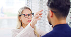 Optometry, choice or woman in shop with glasses, variety or assistance in eyewear option. Healthcare, people or optometrist in store with specs, eye wellness or optical selection in customer service