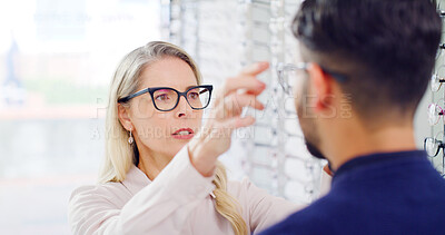 Buy stock photo Optometry, choice or woman in shop with glasses, variety or assistance in eyewear option. Healthcare, people or optometrist in store with specs, eye wellness or optical selection in customer service