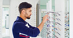Health, man and shopping for glasses, vision and eyesight improvement with choice at shelf. Store, eyewear and person with frame for optometry, check spectacles and customer with lens for eye care