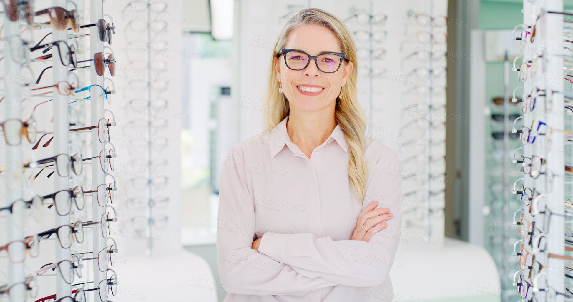 Buy stock photo Arms crossed, portrait and optometry with happy woman in glasses store for consulting or service. Prescription eyewear, smile and vision with optometrist in retail shop for eyesight correction