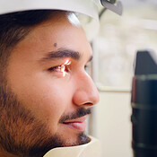 Man, eye test and laser machine for optometry inspection, eyesight ...