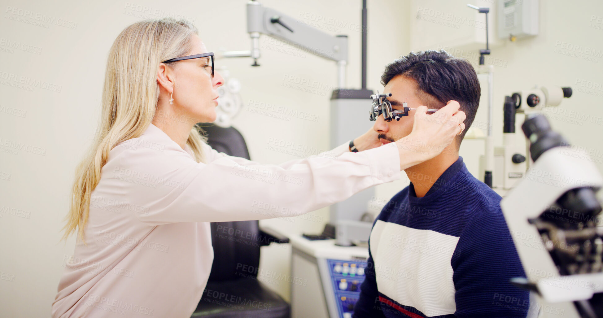 Buy stock photo Optometrist, client or trial lens frame for eye exam, vision assessment or consultation for clear sight. Patient test, optometry or people with tool to determine prescription, iris health or clinic