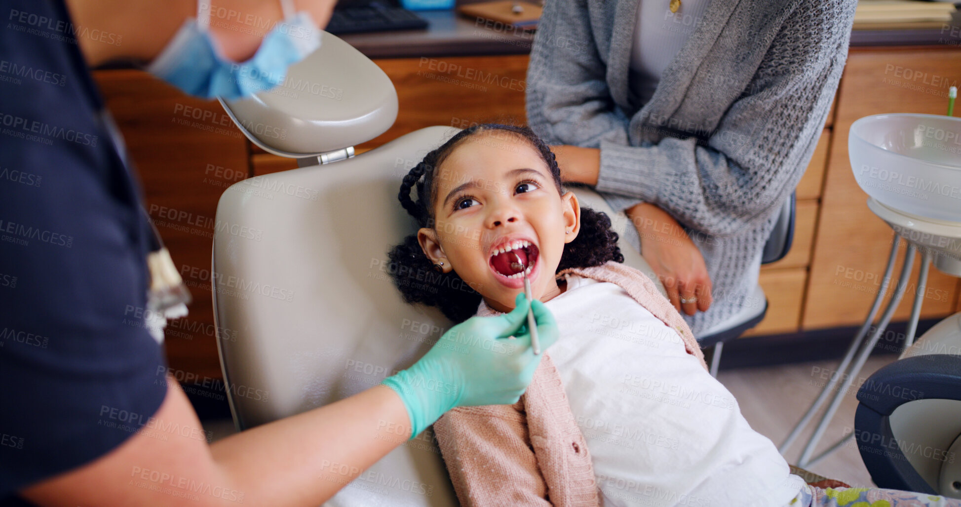 Buy stock photo Pediatric dentist, child and teeth inspection in consultation for oral hygiene, healthcare and wellness. Dental hygienist, girl and mouth exam in office with tools, medical assistance and evaluation.