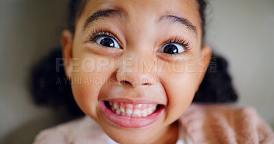 Buy stock photo Excited, portrait and smile of girl child in studio for emotions, expression or reaction to good news. Optimism, teeth and youth with happy kid on gray background for development, growth or surprise