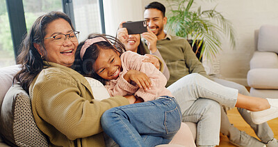 Buy stock photo Happy family, playing and home with child on sofa for fun childhood, love or care together. Parents, selfie and grandma tickling granddaughter with smile for weekend, holiday or bonding in house