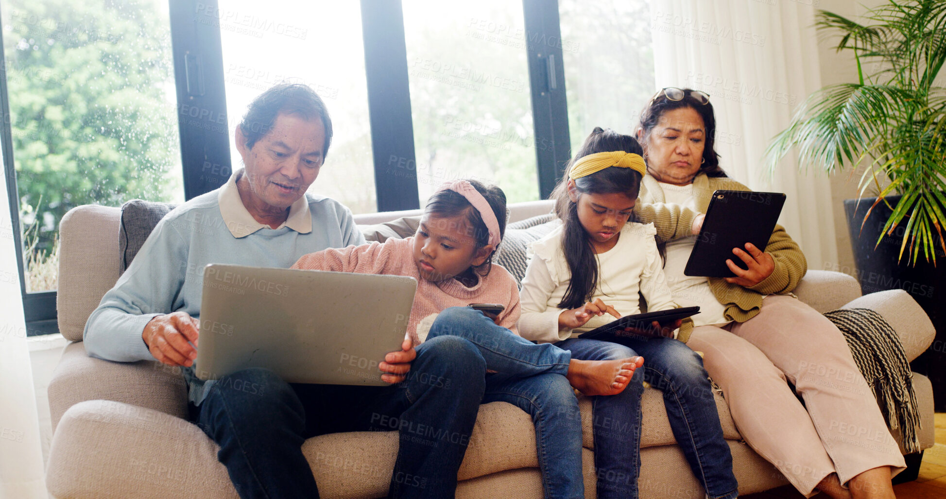 Buy stock photo Tech, relax and grandparents with children on sofa for streaming service, film search and laptop. Online movie subscription, tablet and entertainment with senior people and kids in family house
