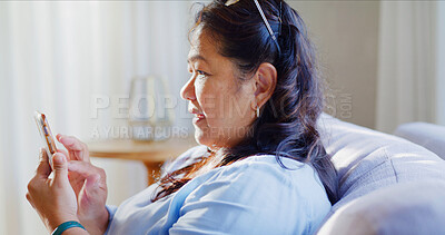 Buy stock photo Reading, woman and scroll with phone on sofa, blog update notification and clear email inbox on weekend. Connectivity, check social media and mature person with mobile in home, ebook app and relax