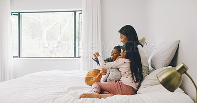 Buy stock photo Relax, mother and kids on bed with tablet on weekend morning, bonding and streaming movie together. Social media, subscription site and girls with woman in family home, tech and online film platform