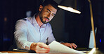 Business man, document and laptop at night for trading algorithms, risk management and planning. Overtime, trader and tech with paperwork in office for market analysis, investment report and review