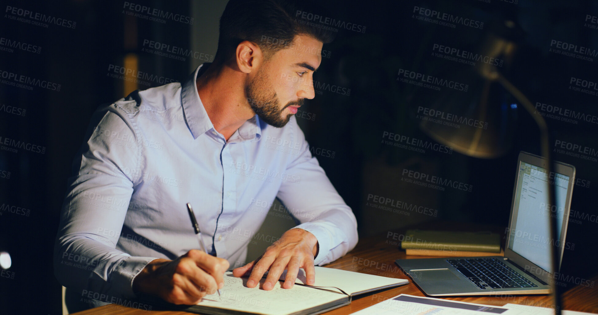 Buy stock photo Notebook, laptop and businessman in office at night with research for finance report with budget. Writing, corporate career and male financial manager working on investment proposal with deadline.
