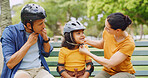 Getting ready, helmet and safety with family in park together for bonding, child development or fun. Bench, headwear or protection with mom, dad and daughter people outdoor for responsibility
