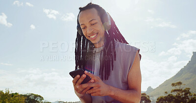 Buy stock photo Black man, headphones and phone with smile outdoor, streaming and listen to music with space. Person, smartphone and happy with audio subscription, sky or scroll for song on mobile app in summer