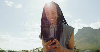 Buy stock photo Black man, headphones and happy with phone outdoor, streaming and listen to music with space. Person, smartphone and smile with audio subscription, sky or scroll for song on mobile app in summer