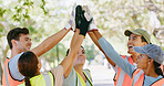 Volunteer, group and high five with goal at park for success, support or stop pollution in summer. People, team building and happy for social responsibility, celebration or excited for sustainability