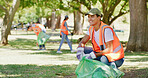 Volunteer, cleaning and happy man in park with bag to collect trash, garbage or litter for pollution. Outdoor, earth day and person with plastic for community service, recycling or environmental care