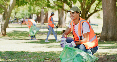 Buy stock photo Volunteer, cleaning and happy man in park with bag to collect trash, garbage or litter for pollution. Outdoor, earth day and person with plastic for community service, recycling or environmental care
