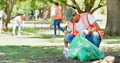 Buy stock photo Volunteer, cleaning and man in park with plastic bag to collect trash, garbage and litter for pollution. Outdoor, earth day and person in nature for community service, recycling and environment