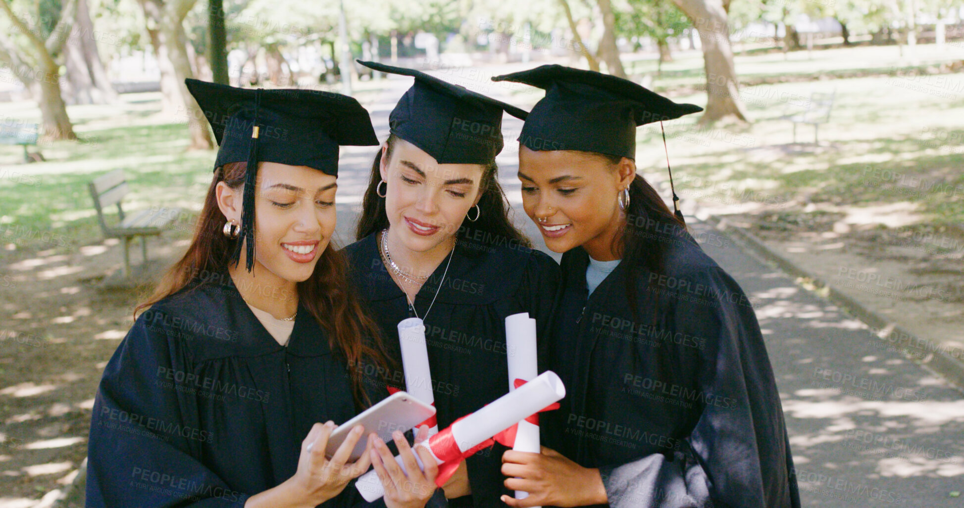 Buy stock photo Women, phone and students at park for graduation, happy and certificate for education goals at campus. People, group and smartphone with discussion, diploma or success with achievement at university