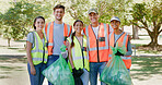 Volunteer, cleaning and portrait of team in park with bag to collect trash, plastic and litter for pollution. Outdoor, happy and men and women for community service, recycling and environmental care