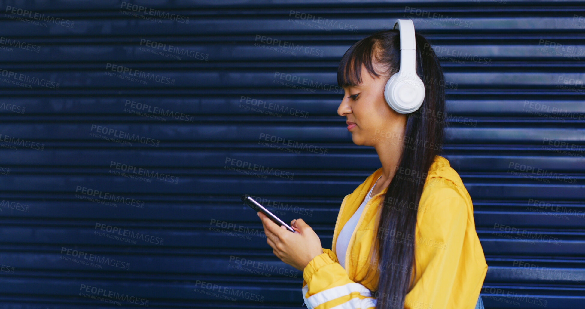 Buy stock photo Streaming, choice and girl with headphones, radio and podcast selection in digital entertainment. Space, gen z and female person with phone, playlist option or listening with music subscription.