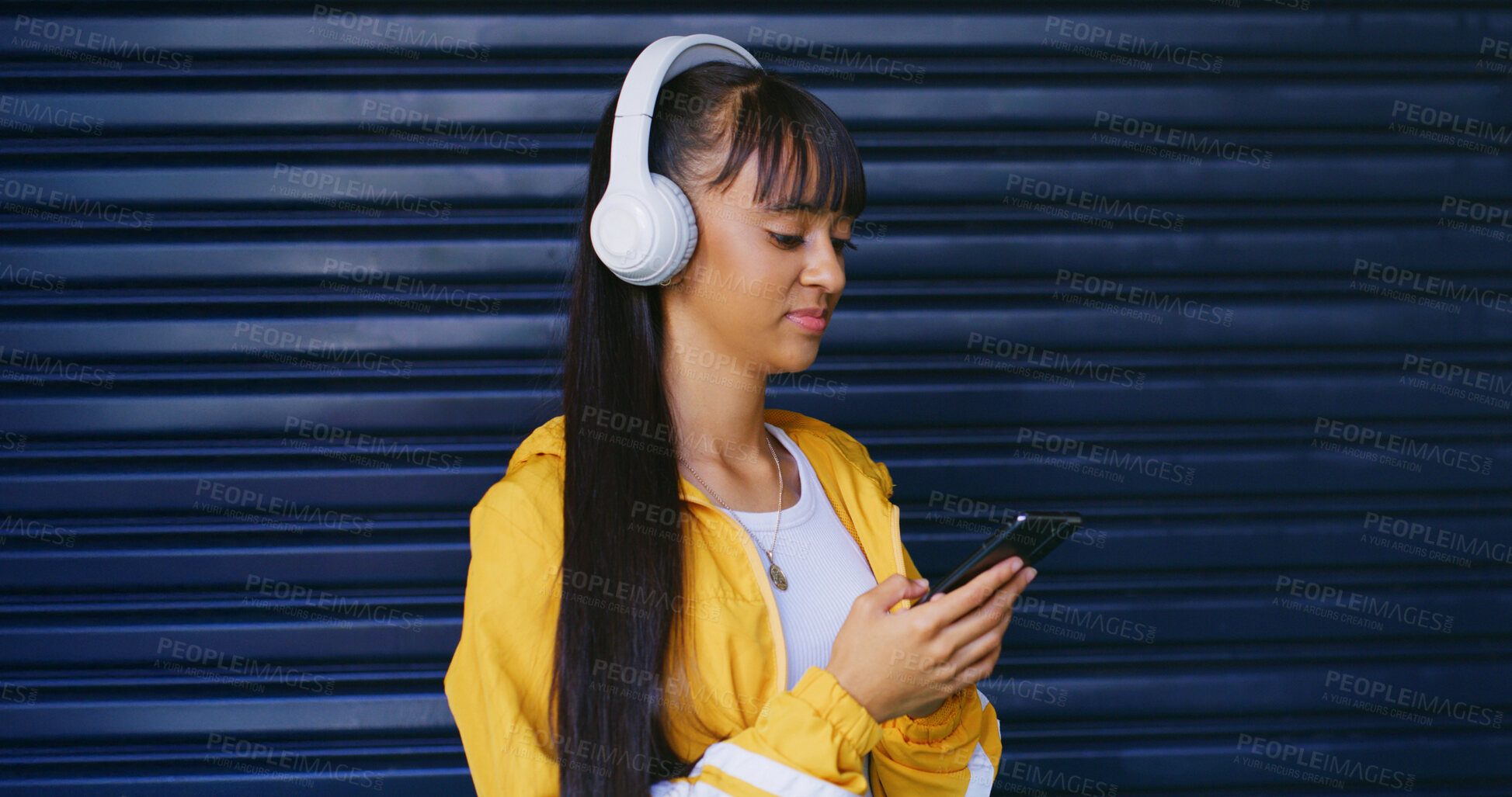 Buy stock photo Streaming, option and girl with headphones, radio and podcast selection in digital entertainment. Reading, gen z and female teenager with phone, playlist choice or listening with music subscription.