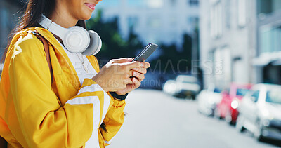 Buy stock photo Phone, text and hands in city with scroll, social media update and message reply on commute. Digital, space and girl in urban area with technology, app browse and online chatting on outdoor walk.