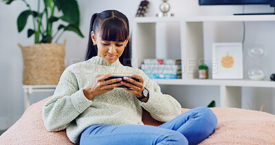 Buy stock photo Home, smartphone gaming and teenage girl on sofa, relax and esports in living room. Apartment, happiness and child on couch, cellphone and digital app for online score, internet and connection