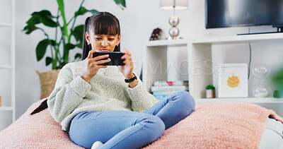 Buy stock photo House, smartphone gaming and teenage girl on sofa, relax and connection in living room. Network, competition and child on couch, cellphone and digital app for online score, internet and esports