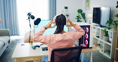 Buy stock photo Back of girl, gaming and computer with headphones for streaming, esports and online hobby in home. Mic, gen z content creator and streamer with video game, tournament or internet challenge for vlog