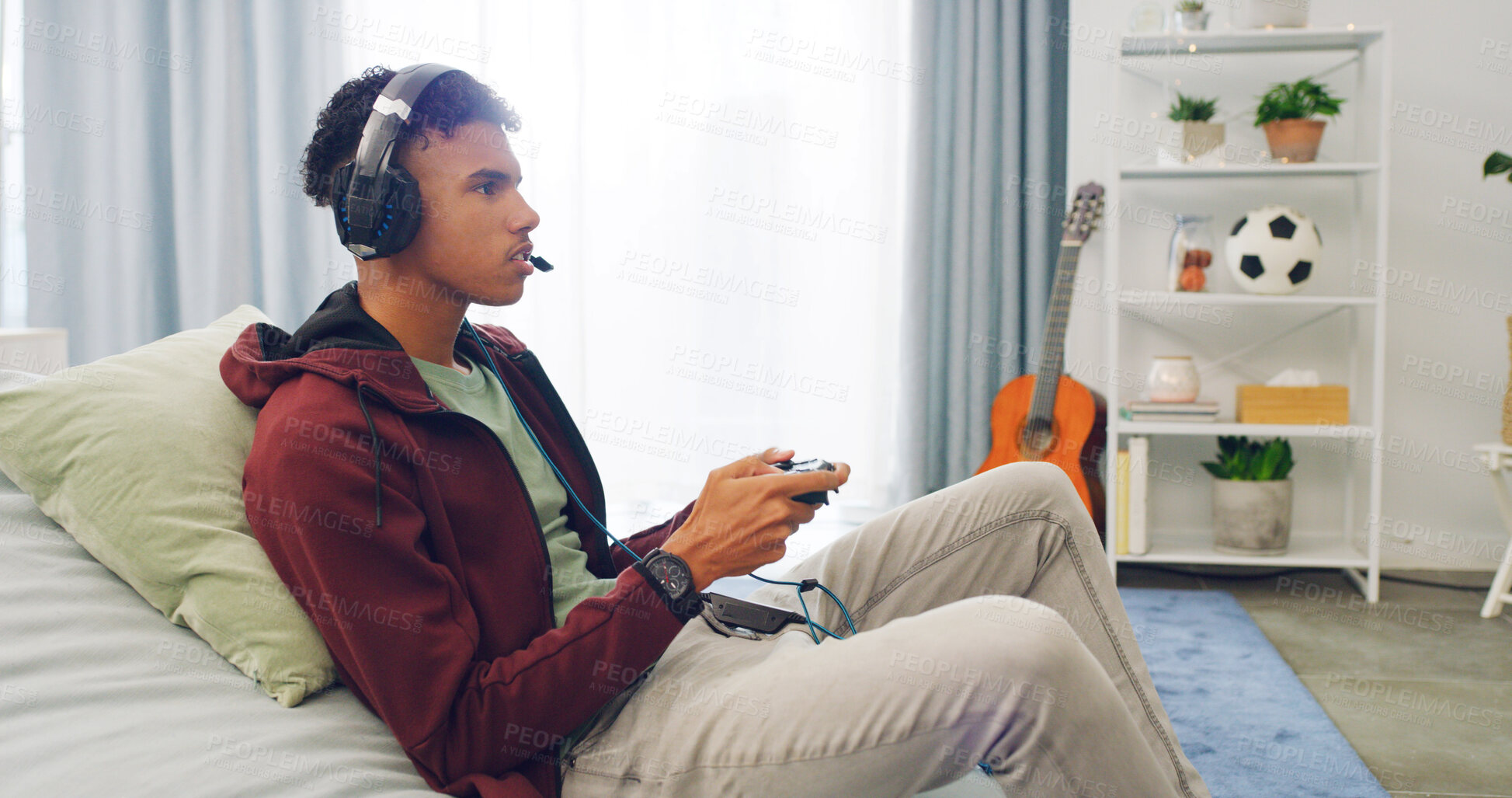 Buy stock photo Couch, esport and teenager playing video game with controller in living room for online challenge in home. Gamer, headphones and male person for streaming, entertainment or virtual competition