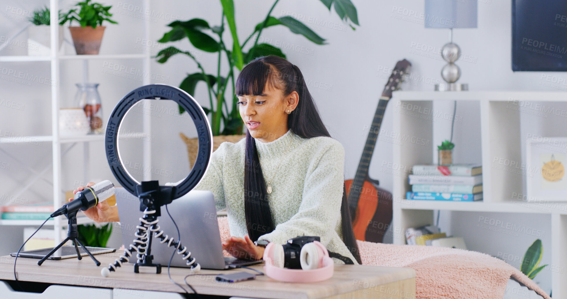 Buy stock photo Woman, laptop and influencer with typing, home and guitar teacher with video editing for content creation. Person, computer and recording tech for web show, podcast or music tutorial on social media