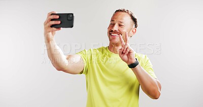 Buy stock photo Selfie, peace sign and fitness with man in studio for social media gym membership promotion and memory. Profile picture, personal trainer post and photography with person on white background