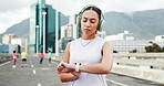 Headphones, smart watch and woman in city for exercise, marathon training and tracking workout. Sports, athlete and person with tech for wellness, health stats and music for fitness in urban town