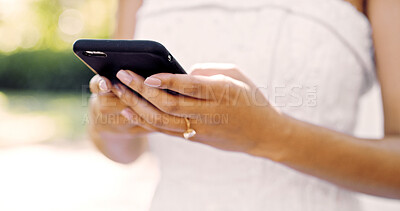 Buy stock photo Hands, bride and phone with texting on wedding day, contact and check post on social network. Person, smartphone and scroll on mobile app for marriage video, notification and gown for ceremony