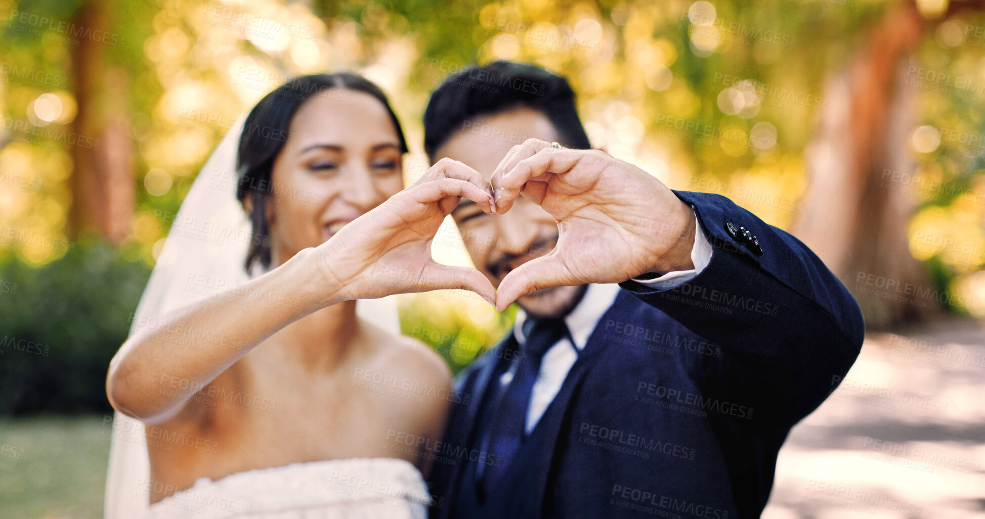 Buy stock photo Happy couple, love and wedding with heart hands for marriage, commitment or relationship in garden. Man, woman or lovers with smile, emoji or trust for honeymoon, loyalty or vow together in nature